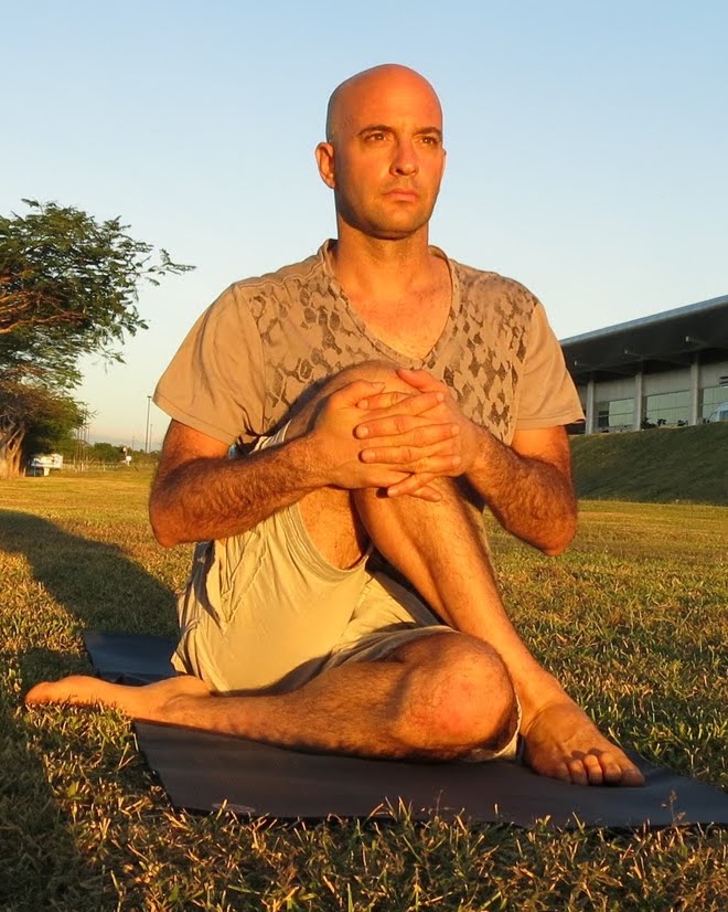 Jonathan in a seated twist on a mat outdoors